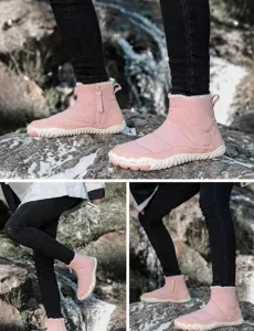 Close-up of pink waterproof snow boot with thick faux fur lining and side zipper detail