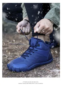 Close-up of tying laces on navy blue winter outdoor boots with warm fleece lining