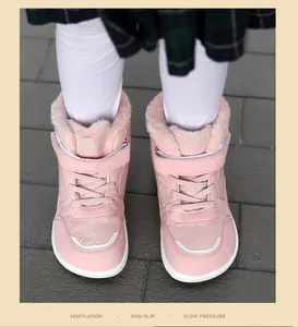 Detail view of pink children's winter boots with warm plush lining and non-slip sole
