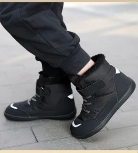 Detailed macro view of black winter snow boot with warm fleece lining and Velcro strap