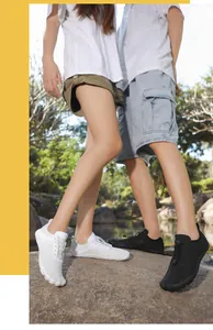 Outdoor couple wearing breathable quick-dry barefoot water shoes on a natural landscape