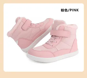 Detailed view of pink children's winter boots with warm faux fur lining and velcro straps