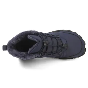 Close-up of waterproof snow boots featuring gray faux fur lining and toggle lace system