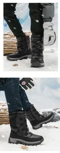 Close-up of black winter snow boots with durable anti-slip soles and warm fur lining