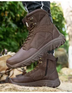 Detail view of brown tactical boots featuring side zipper and durable rubber outsole