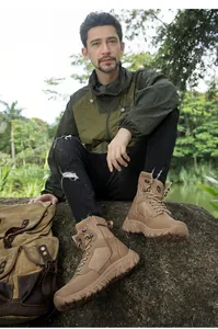 Detail of tan tactical combat boot with leather fabric stitching and non-slip rubber sole