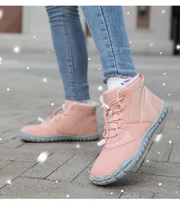 Pink winter snow boots with white plush lining and elastic drawstring for outdoor warmth