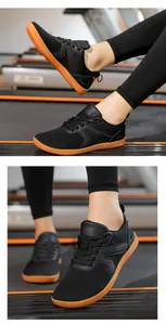 Macro detail of breathable black barefoot shoe with non-slip rubber sole on treadmill