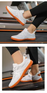 Detailed view of white mesh upper and orange rubber sole on barefoot running shoes