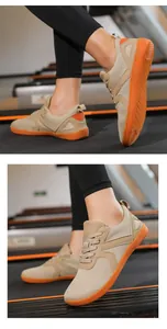 Close-up of breathable mesh barefoot shoes with non-slip orange rubber soles on treadmill