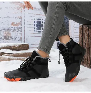 Waterproof winter snow boots with plush lining on snowy ground showing outdoor grip