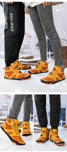 Detail of waterproof winter boots showing traction sole, fleece lining and toggle laces