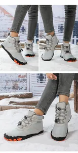 Detail view of light grey mid-top snow boots with fur lining and anti-slip sole