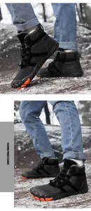 Detail showing high-grip orange textured sole of waterproof winter snow boots for hiking