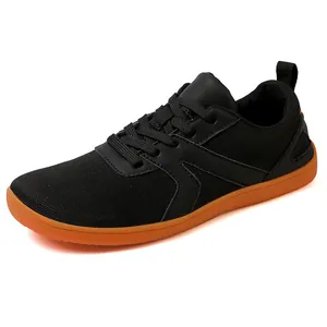 Non-slip barefoot sneakers with black mesh upper and contrasting orange rubber soles