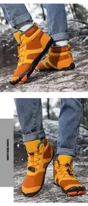 Detail of waterproof orange snow boots with warm fleece lining and toggle drawstring lace