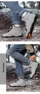 Detail of waterproof winter snow boots featuring warm plush lining and orange non-slip soles