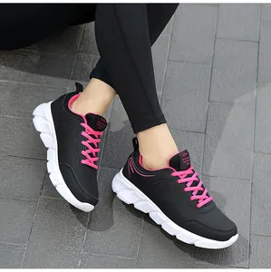 Dettaglio di scarpe da corsa da donna nere e rosa con suole spesse antiscivolo