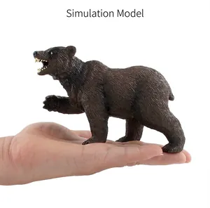Detailed realistic brown bear model being held to show toy size and texture