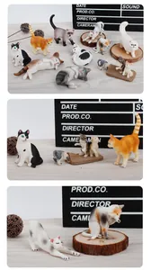 Collection of detailed cat figurines in various poses on a wooden background