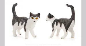 Detailed close-up of a realistic black and white cat figurine with lifelike fur texture