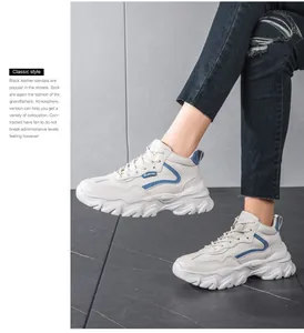 Detail of cream chunky sneakers with blue stripes and thick soles on a female model