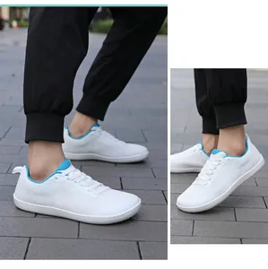 Nahaufnahme weiß-blauer Barfußschuhe mit atmungsaktivem Mesh und Sport-Schriftzug