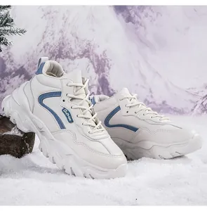 Close-up of white platform sneakers with blue stripes and Suprise tag on snow background