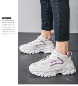 Side view of beige platform chunky sneakers with purple accents and thick serrated soles
