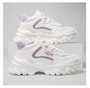 Detail view of beige platform sneakers featuring purple trim and Surprise rubber label