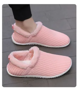 Detail of pink knitted house slippers with warm faux fur lining and white anti-slip sole