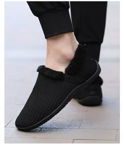Close-up of black knit slip-on men's slippers featuring plush faux fur lining and texture
