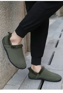 Detail of olive green knitted men slippers with thick warm lining and non-slip rubber sole