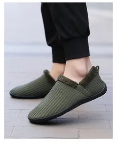 Detail of dark green knitted slippers with warm plush lining shown on a person outdoors