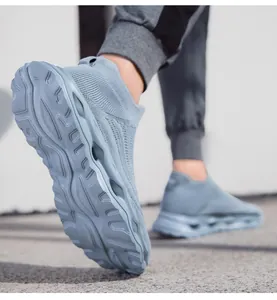 Low angle shot of light blue knit sneakers showing hollow cushioning midsole and wavy sole