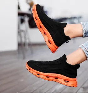 On-foot view of breathable knitted slip-on sneakers with orange hollowed-out thick soles