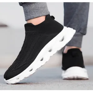 Close-up of black breathable knit upper with hollow white platform sole on sports shoes
