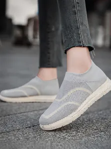 Macro shot of grey breathable knitted upper and soft slip-on collar of these sports shoes