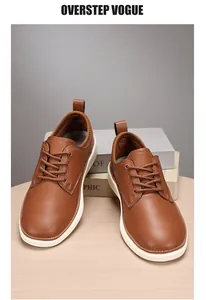 Detailed view of brown leather casual oxford shoes with white soles on wood surface