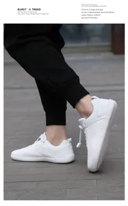 Close-up of white barefoot running shoes with breathable mesh and elastic toggle laces