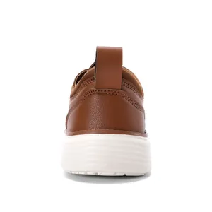 Detail of dark brown leather oxford heel with stitching and white non-slip sole