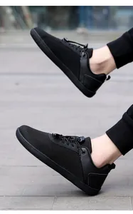Dynamic side view of black barefoot training shoes with breathable mesh and soft soles