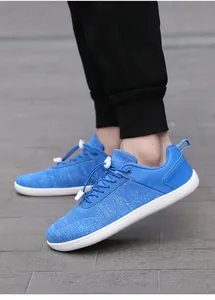 Close-up of blue breathable mesh sneakers with flexible sole and adjustable lace lock
