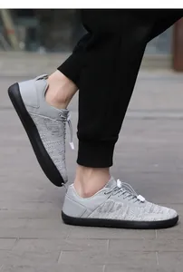 On-foot view of gray breathable wide-toe barefoot sneakers with ultra-thin rubber soles