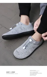 Detail of grey breathable knit barefoot shoes with quick-lace system and black rubber sole
