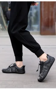 Close-up of barefoot training shoes with knit uppers on feet in an outdoor urban setting