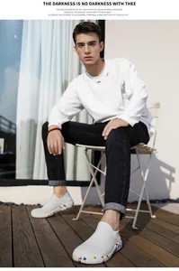 Detail of white knit slip-on sneakers with colorful splash ink pattern on the sole