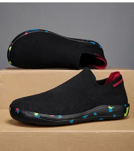 Close-up of lightweight black knit slip-on sneakers with colorful speckled rubber soles