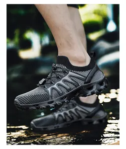 Detail of dark grey water shoes with mesh upper and drainage holes on the outsole