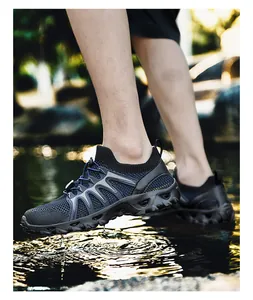 Macro detail of breathable mesh upper and elastic bungee laces on men's river trekking shoes